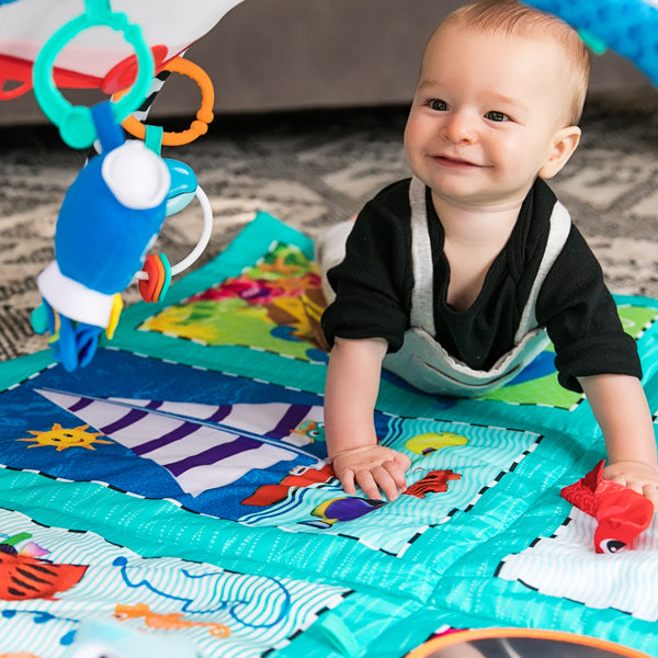 baby playing on a mat baby einstein