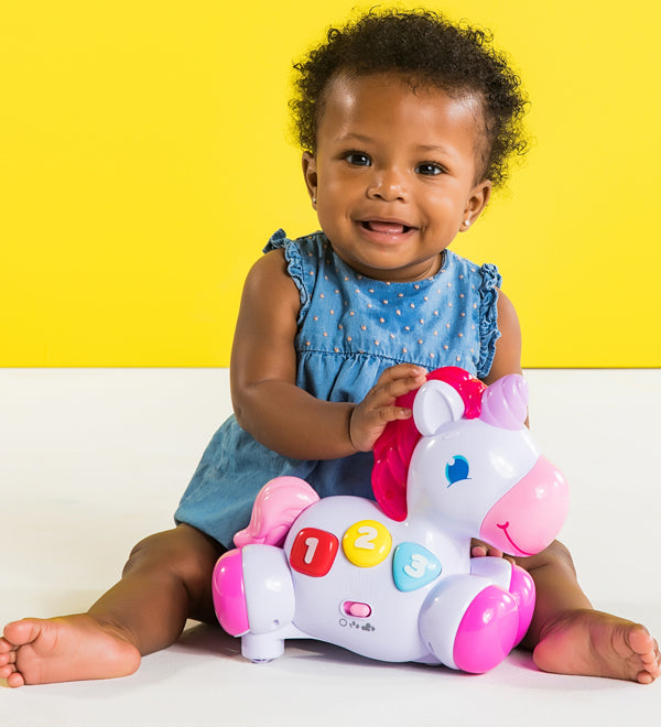young child with plastic horse toy