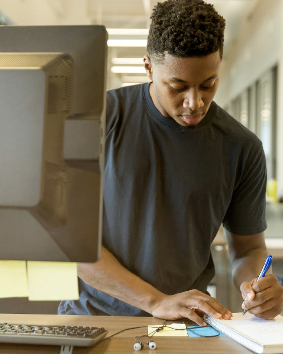 man working at a stand up desk