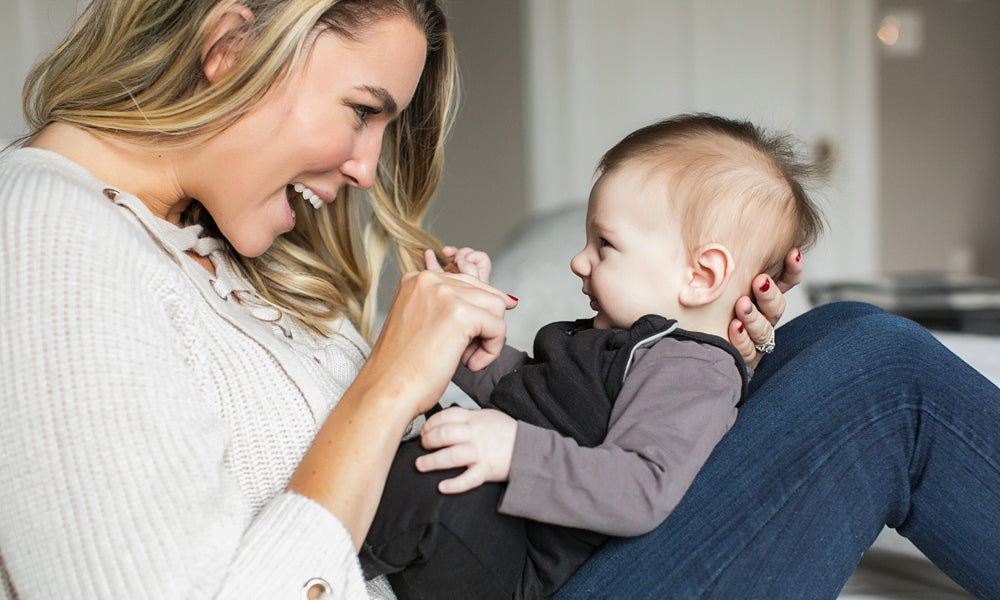 woman holding a baby on her knees